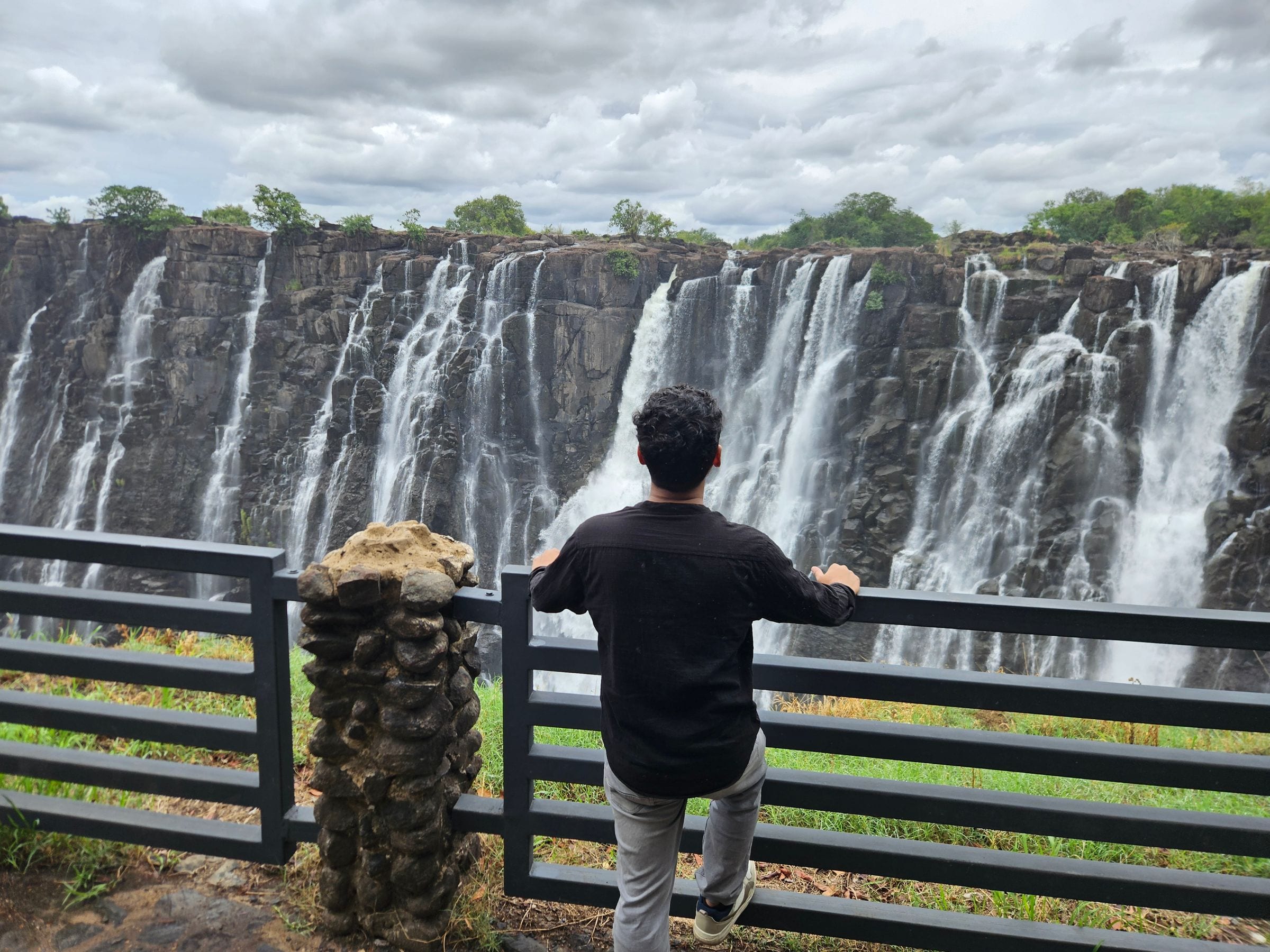 A traveller looking out over Victoria Falls from a viewpoint