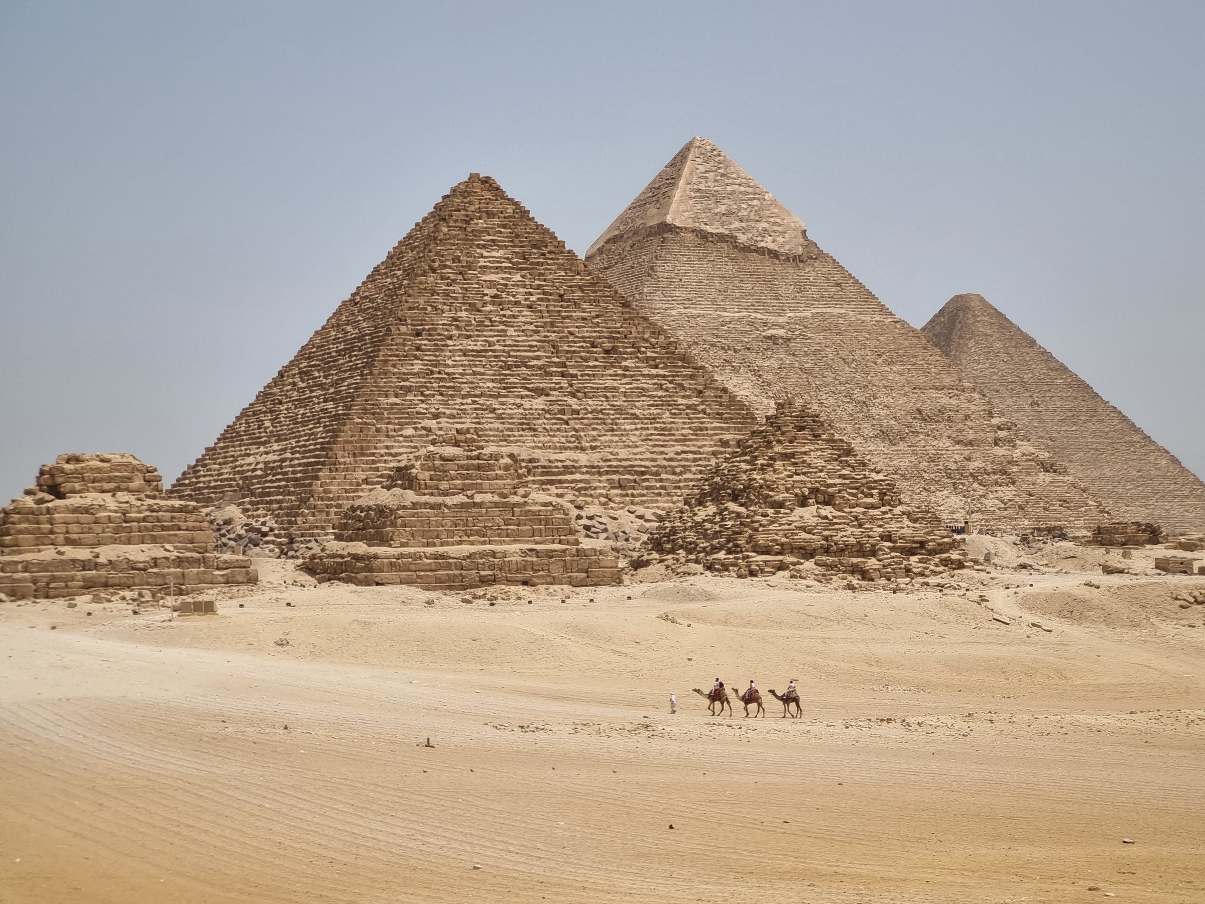 Camel riders below the Pyramids of Giza