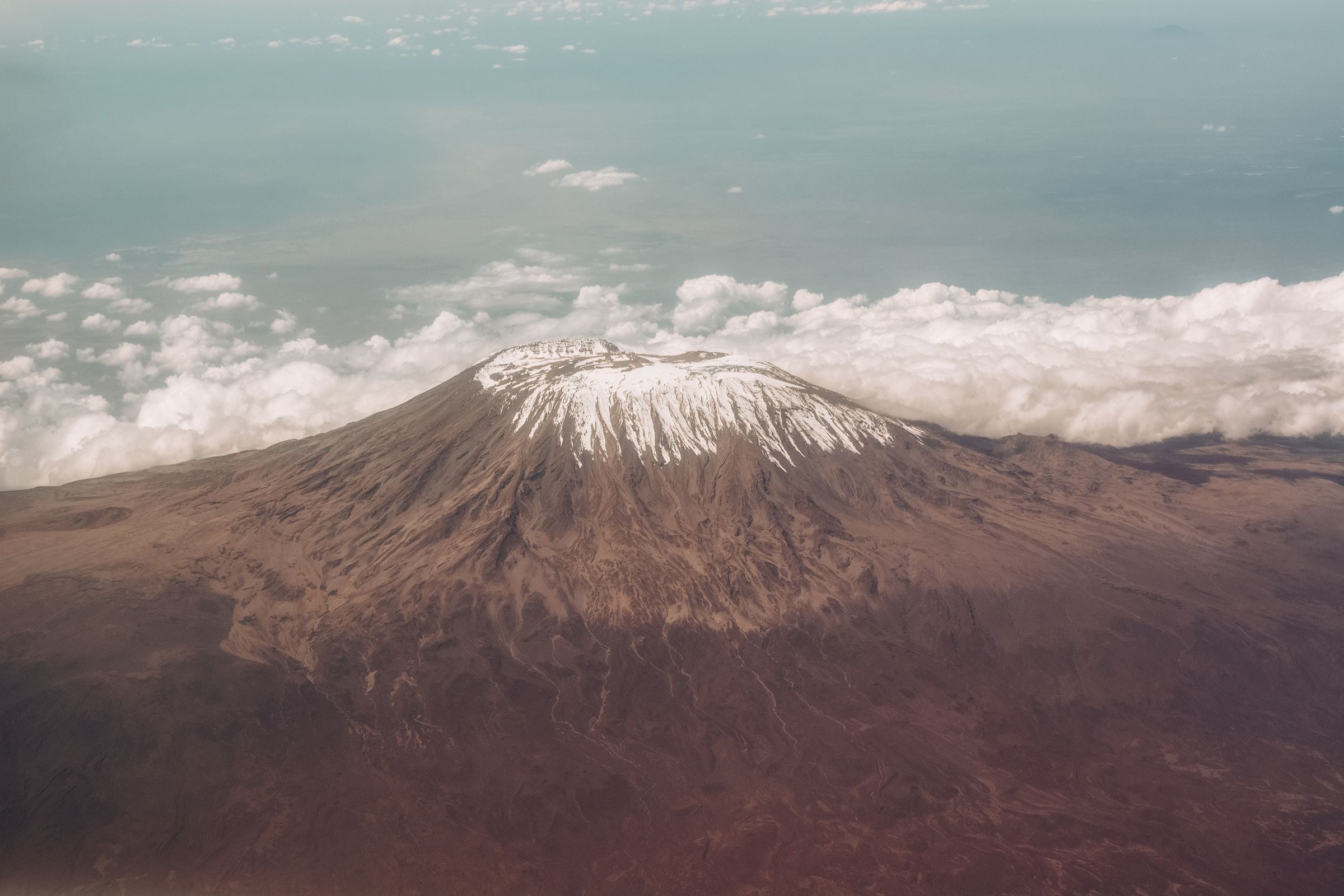 Kilimanjaro's summit rising above the clouds, seen from the air