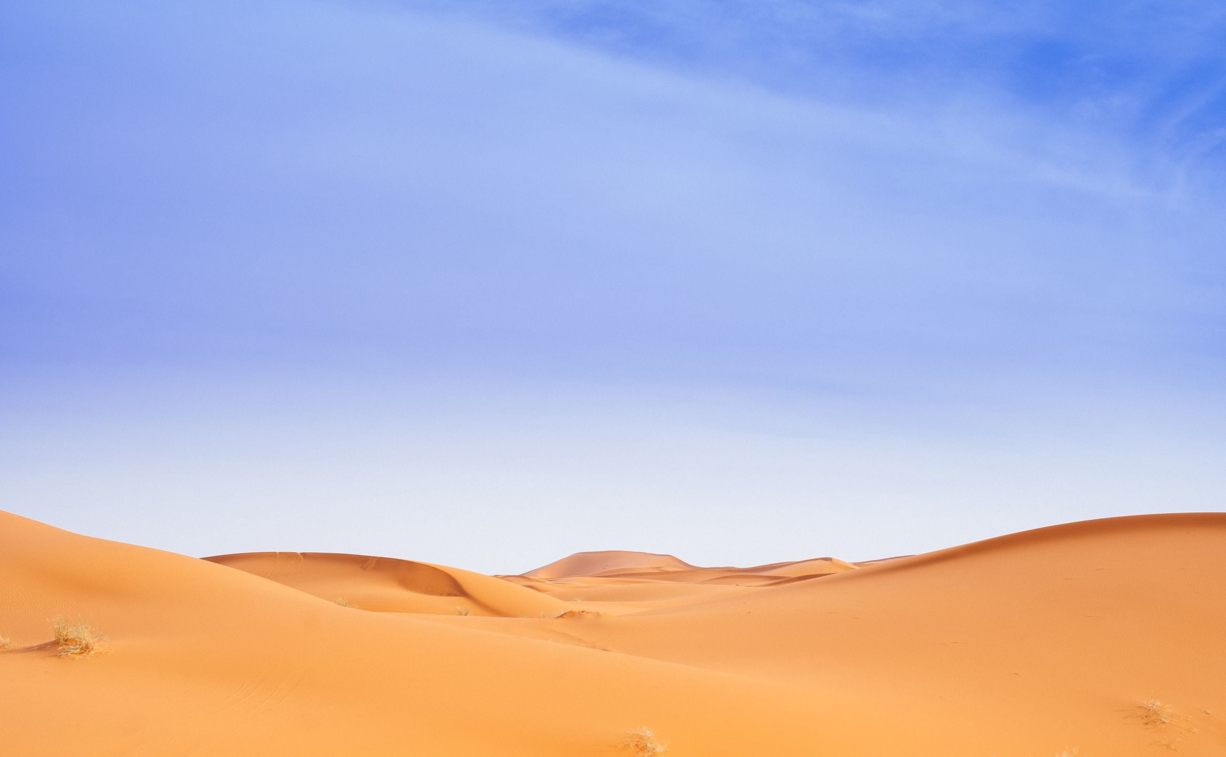 Golden dunes under a blue sky at Merzouga